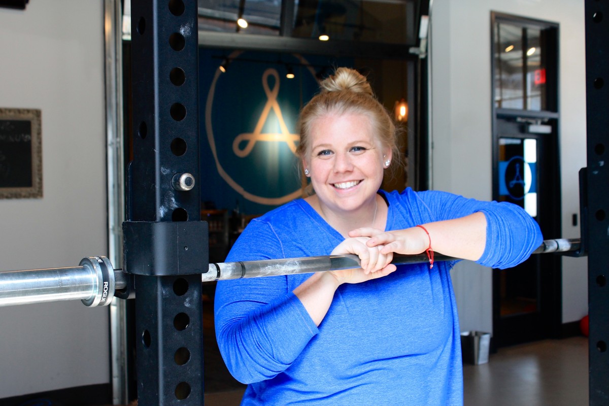 Female Alchemy Athlete smiling during an AStrong class